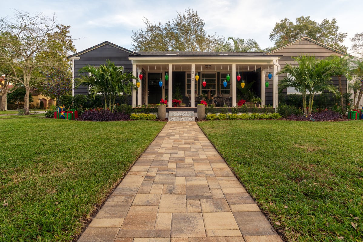 walkway up to home with palm trees