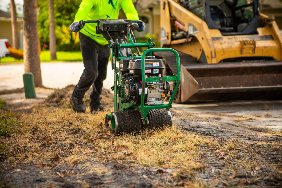 machine rips up old grass