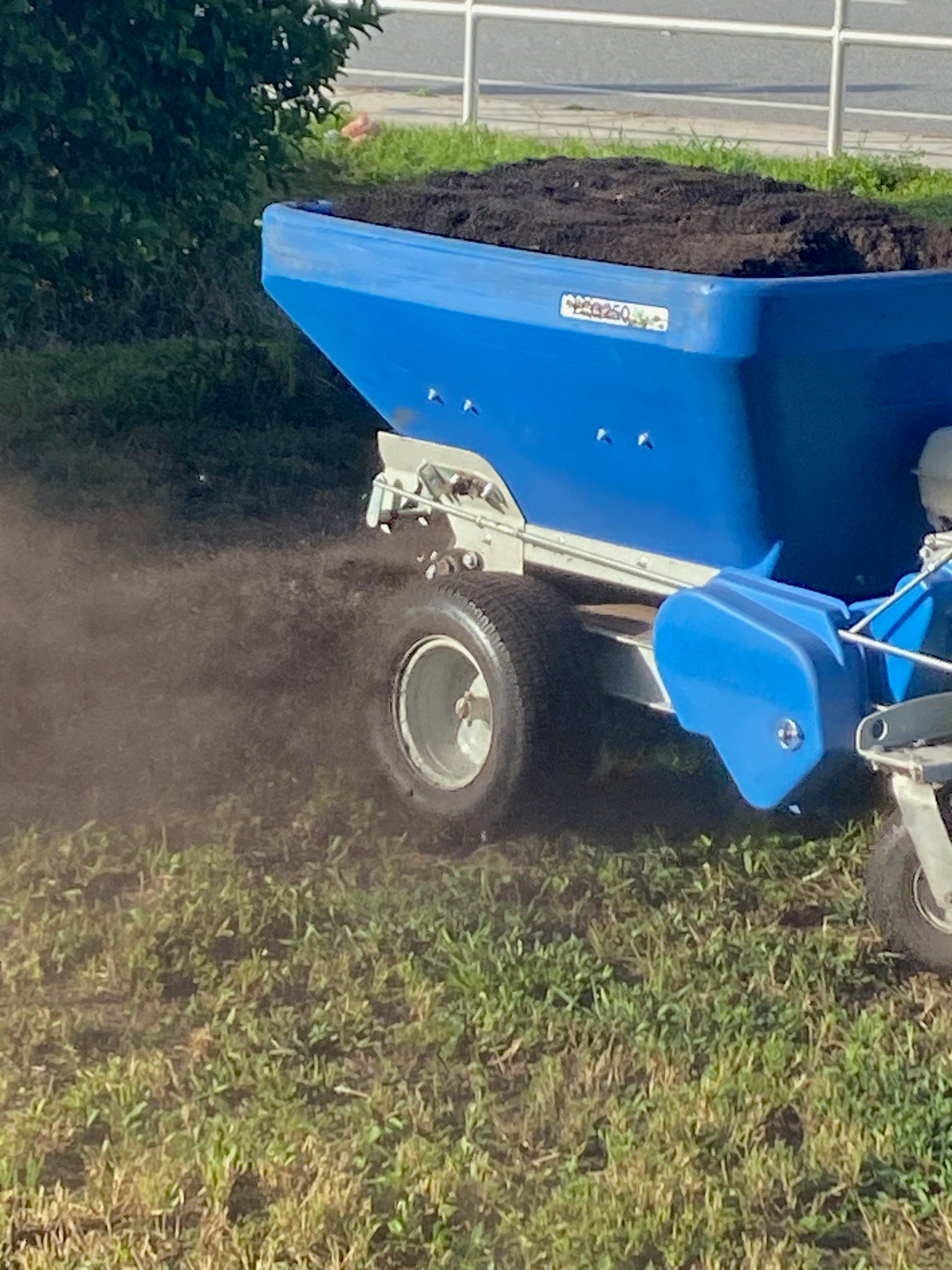 sod topdressing machine spreading soil amendments on sod lawn