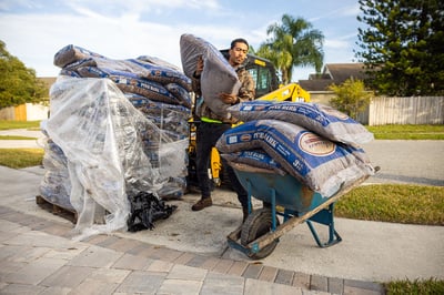 Maintenance crew wheelbarrow mulch