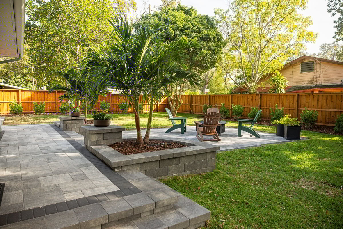 hardscape patio stairs raised planting bed pavers palm trees 3