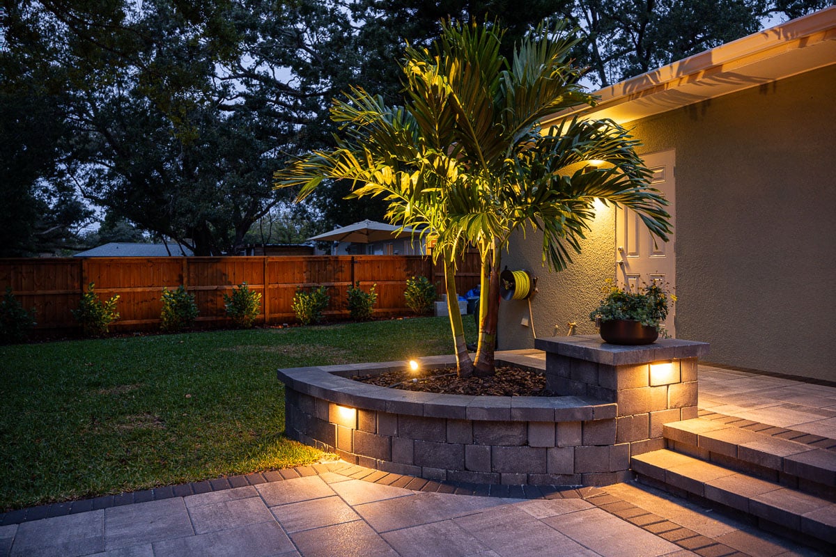 hardscape paver patio raised planting bed landscape lighting palm tree