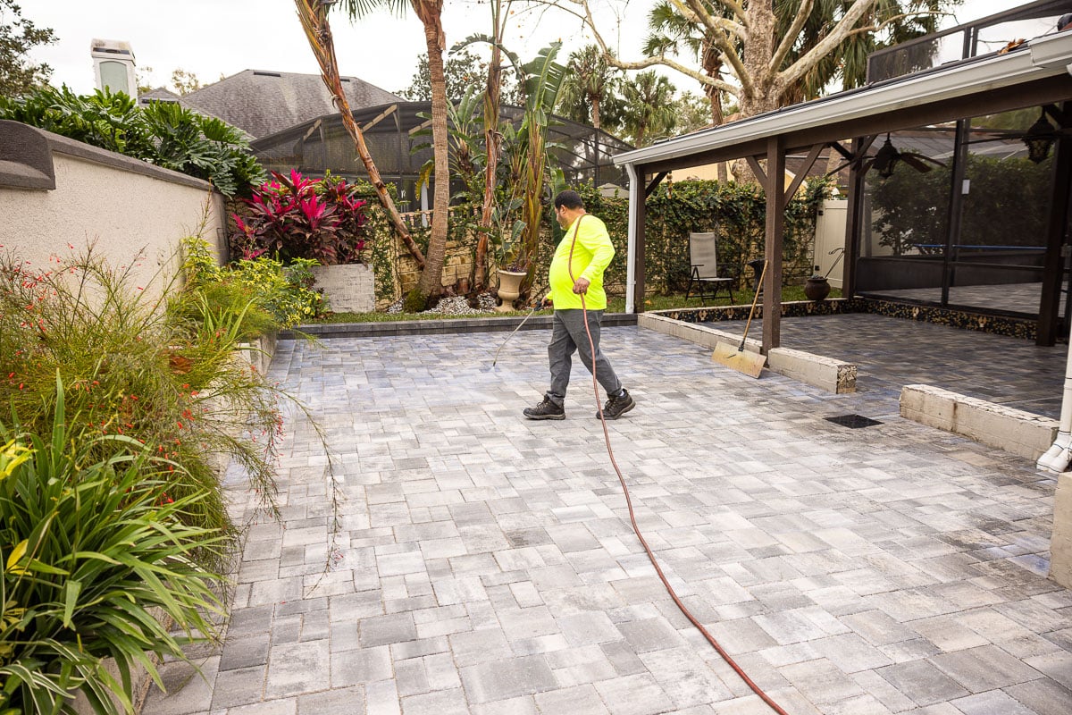 maintenance crew paver sealing slab patio spray 2