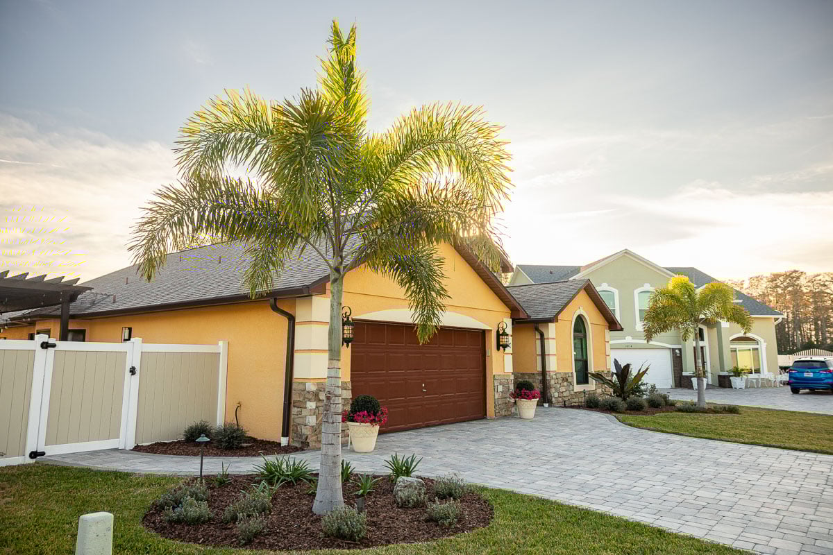 paver driveway planting bed shrubs palm tree 2