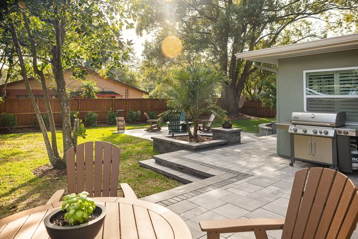 paver patio hardscape outdoor furniture grill house shade trees