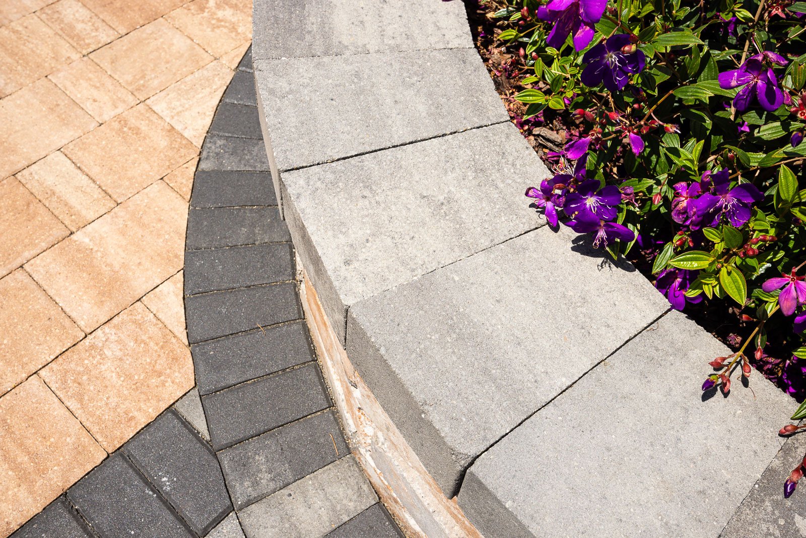 office display pavers and raised planting bed with flowers 3