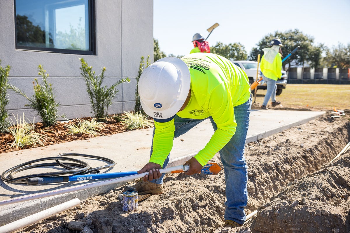 commercial construction irrigation installation warehouse industrial crew team 10