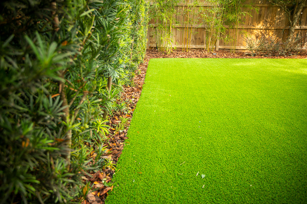 artificial turf installed near landscape beds