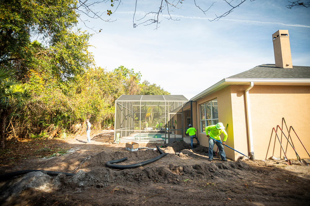 irrigation installation team digs trenches for lines