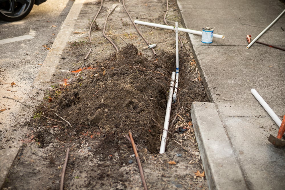 holes dug in dirt for irrigation repair