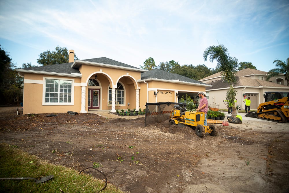 landscape team grades dirt in front  yard to prepare for sod install