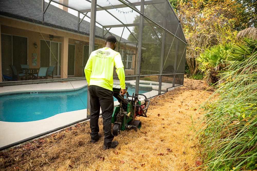 landscape install team removes dead sod near pool