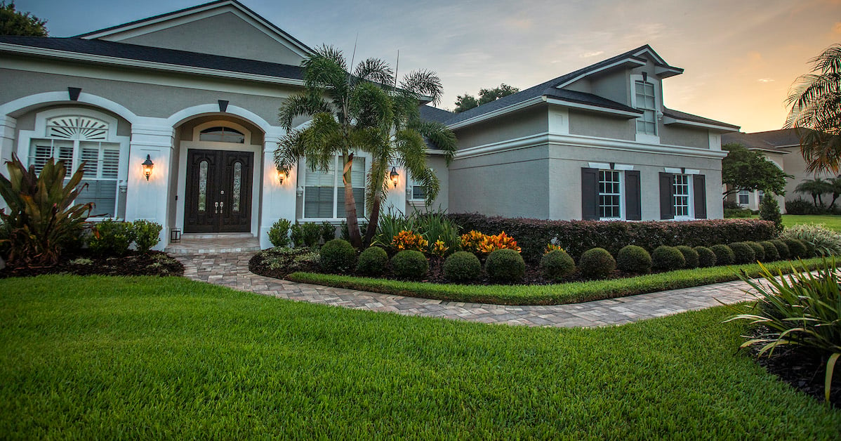 landscape foundation planting beds and stone walkway in front of a florida home