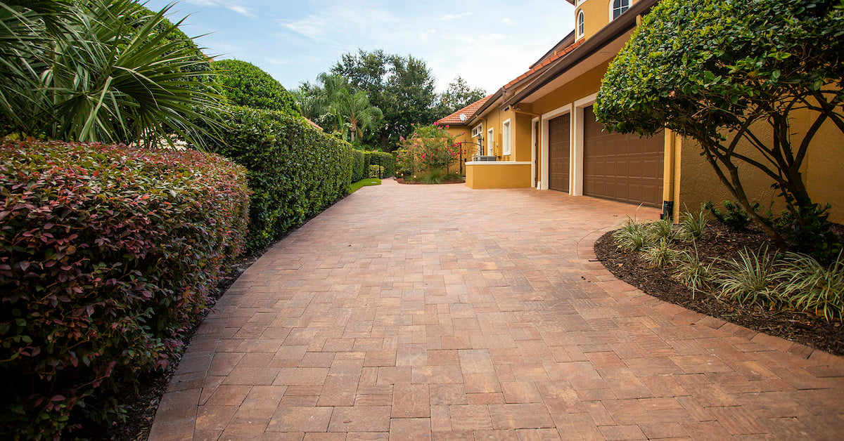 paver driveway with plantings near garage