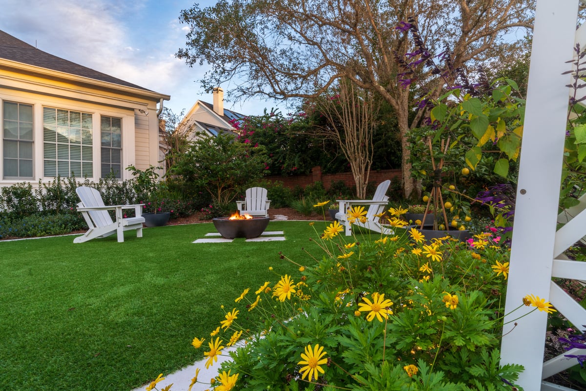 flowering healthy plantings near turf with fire bowl