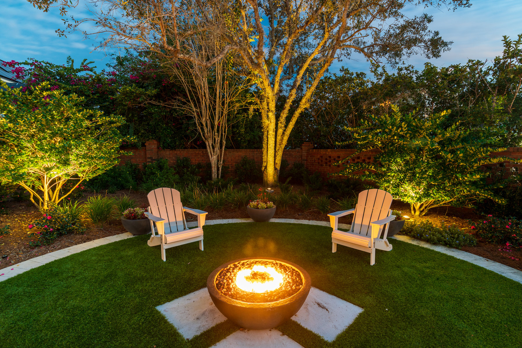 landscape lighting with firebowl and seating area