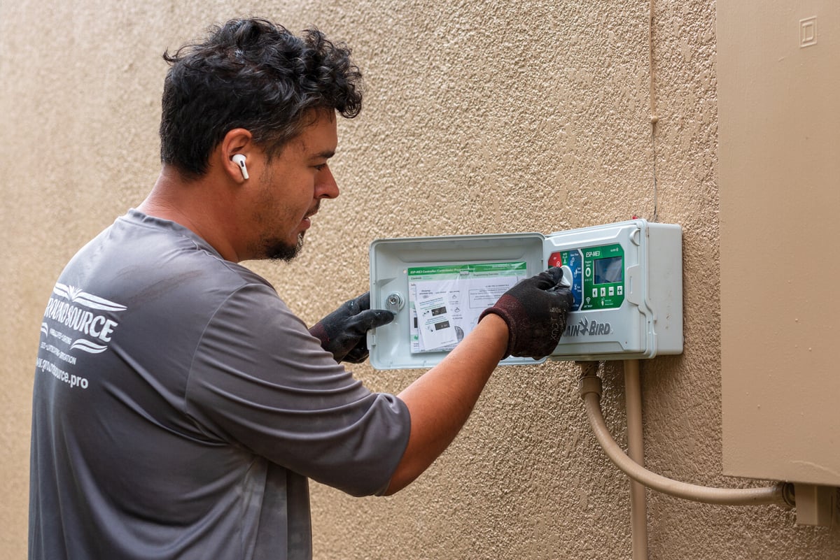 irrigation team inspects controller