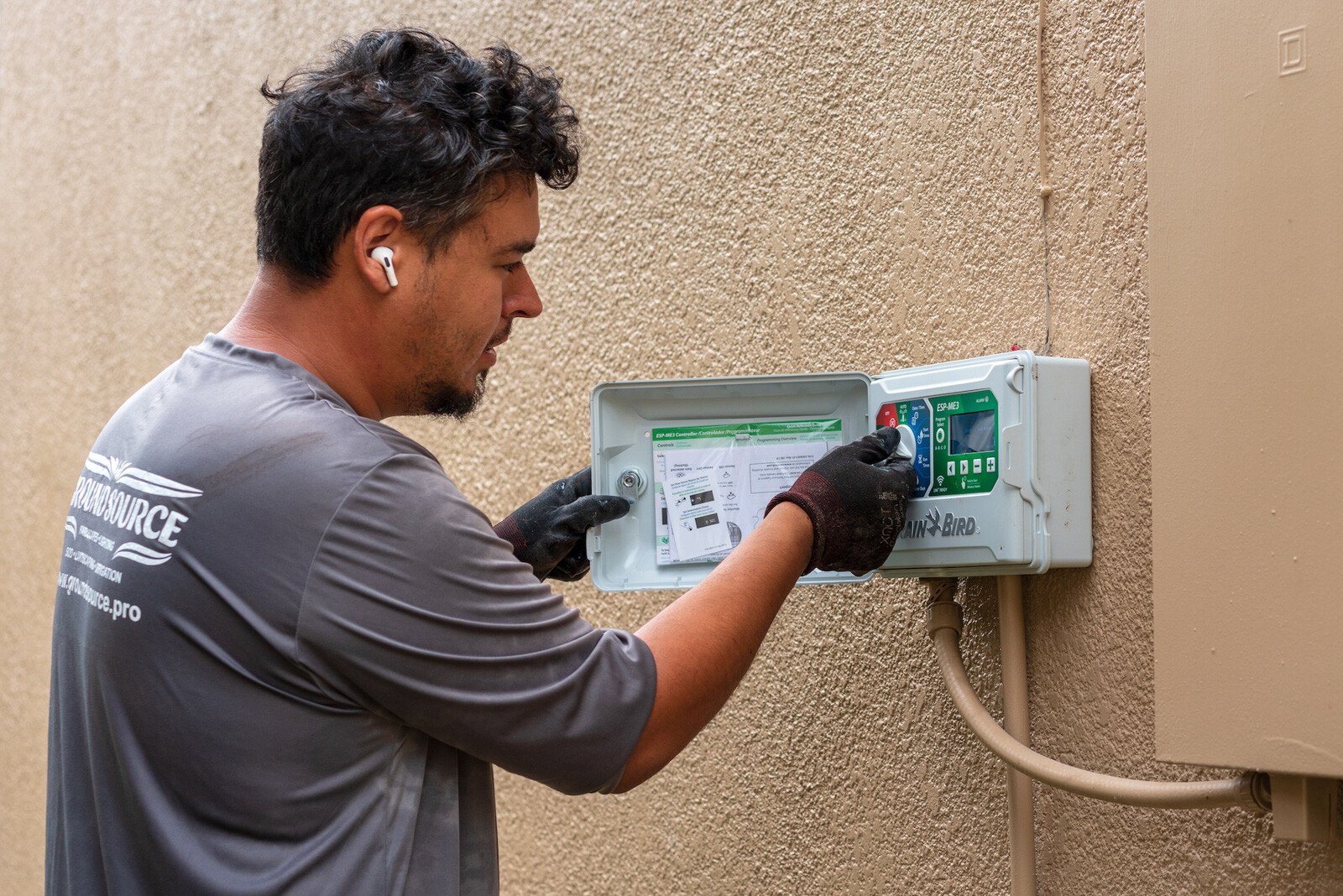 Irrigation team installing a controller