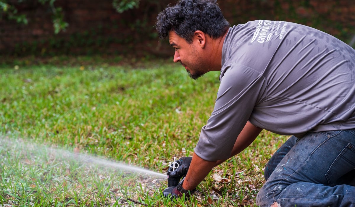 irrigation team adjust sprinkler head