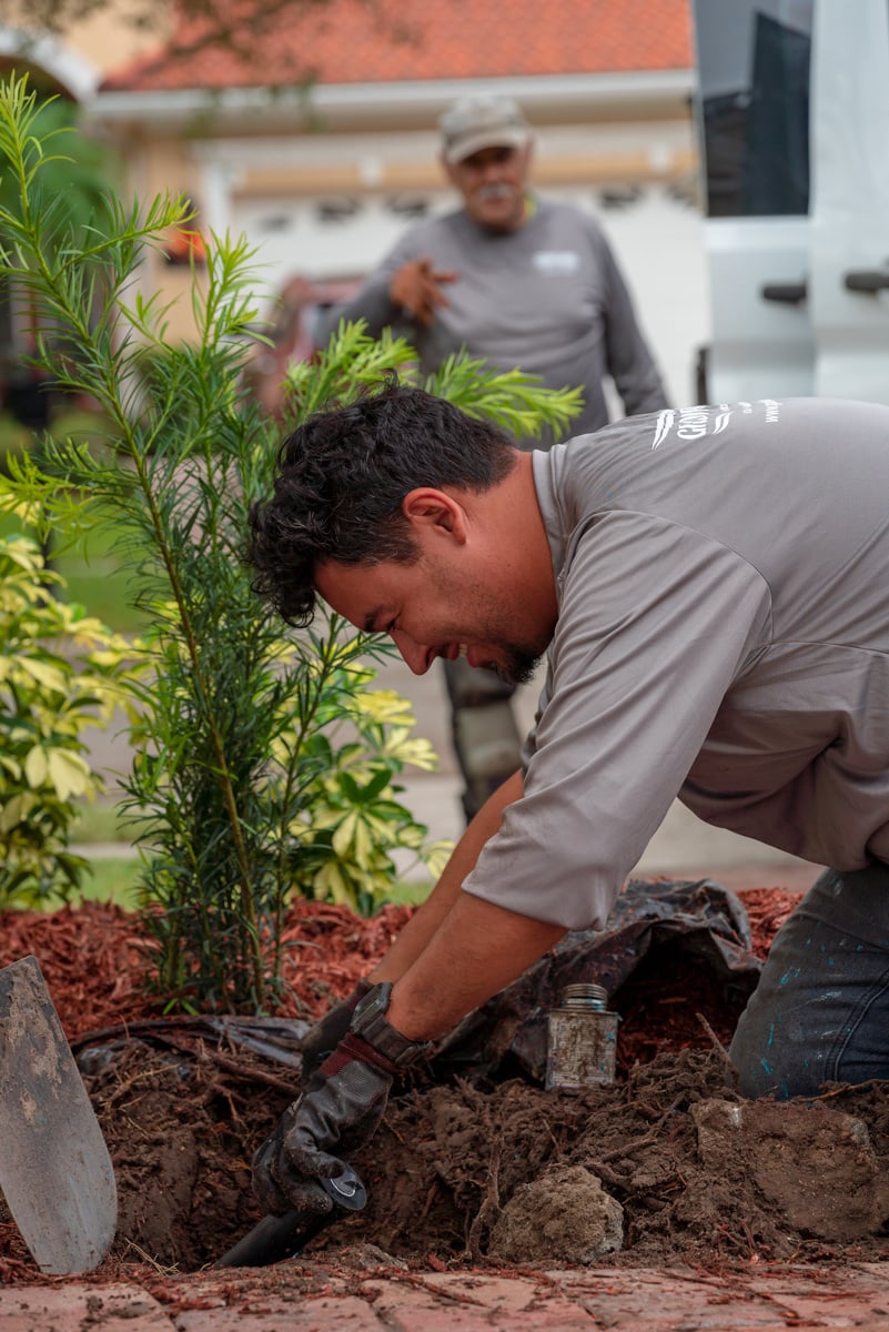 irrigation technician replacing parts of a lawn and garden sprinkler system