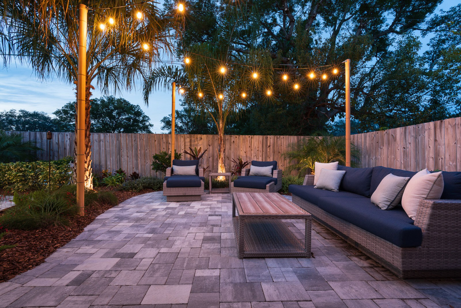 Lounging area with festive lights and paver patio