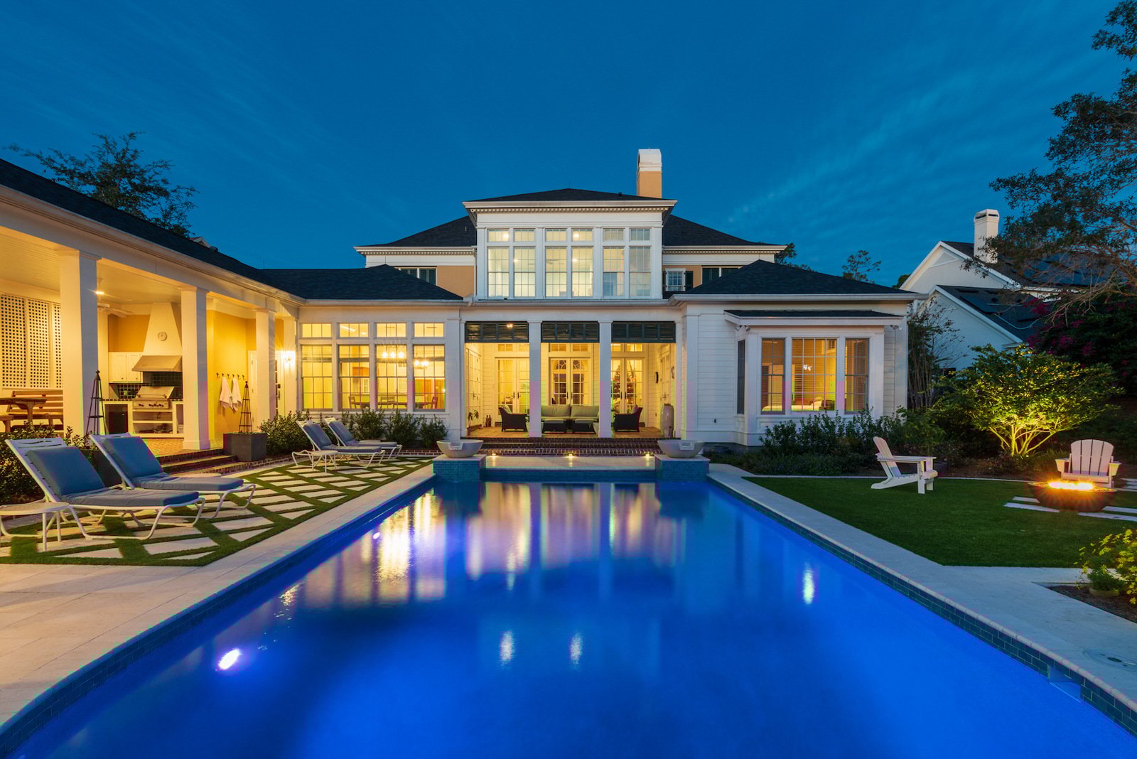 pool artificial turf fire pit seating chairs lighting landscape planting covered paver patio