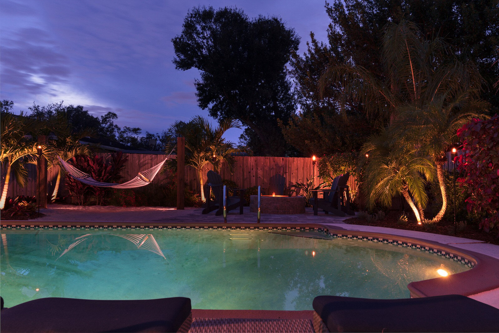 Pool patio with firepit and beach area