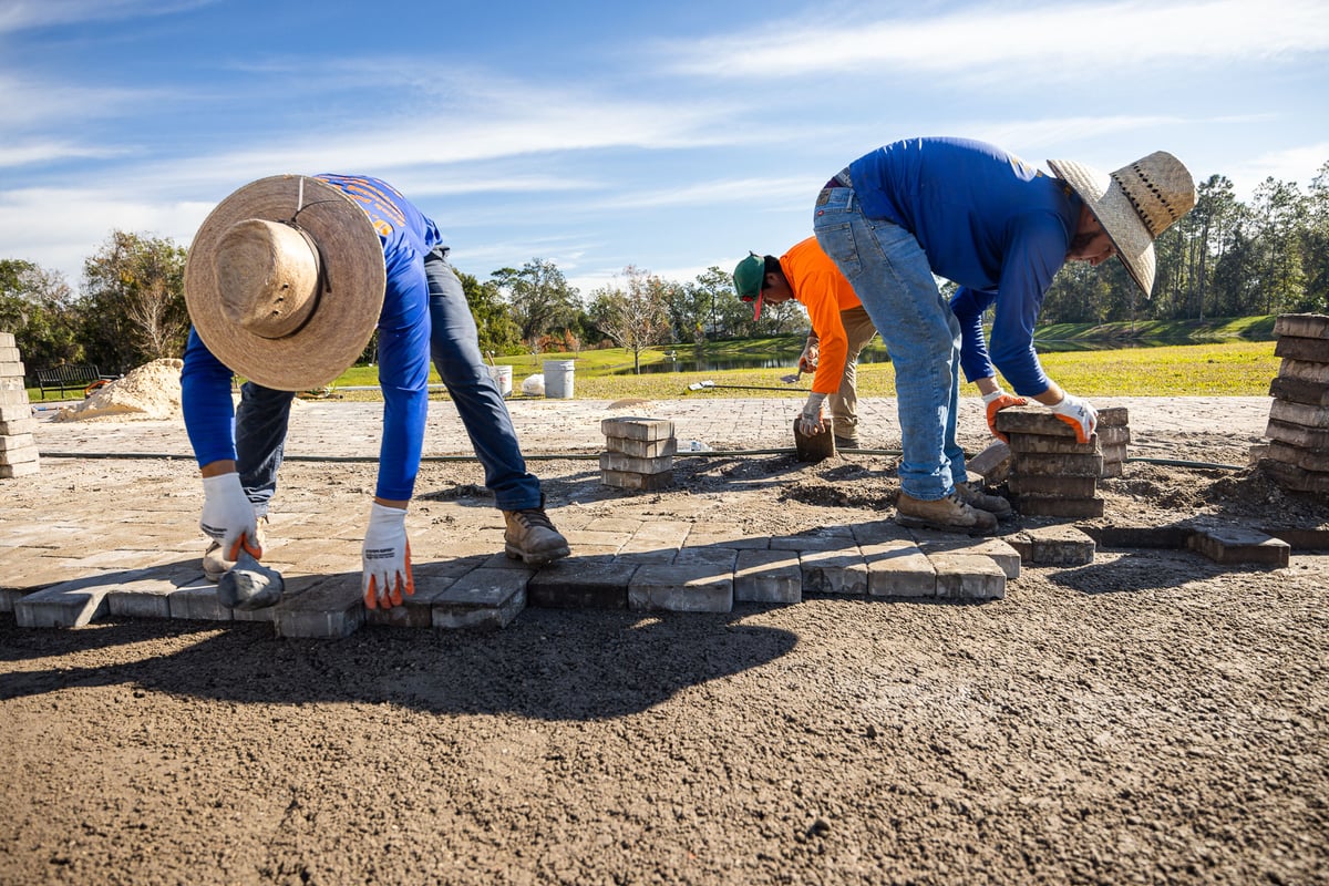 landscape install team installs pavers