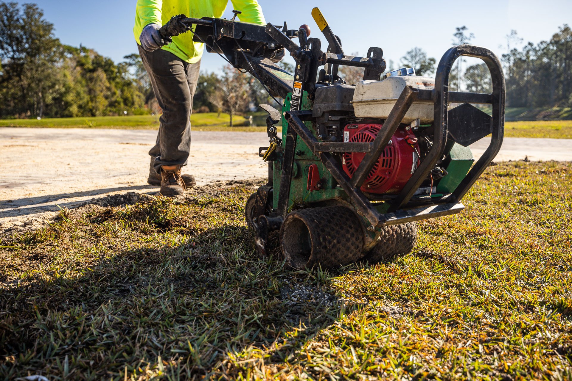 landscape technician and sod cutter for sod removal