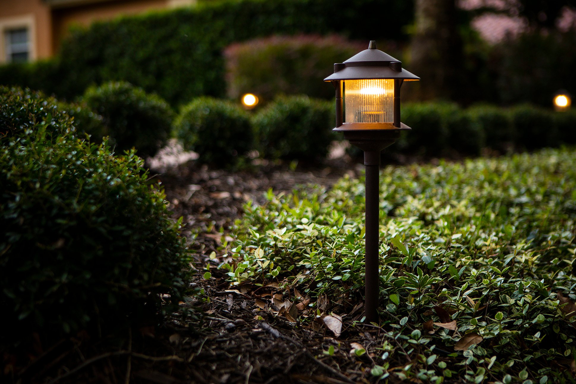 landscape lighting fixture with a cap to direct light down