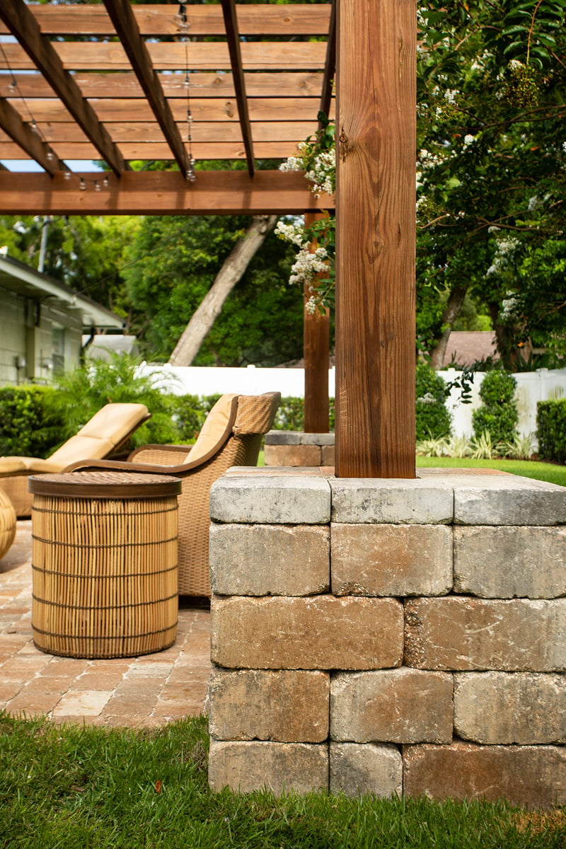 stone column with pergola and flowering tree