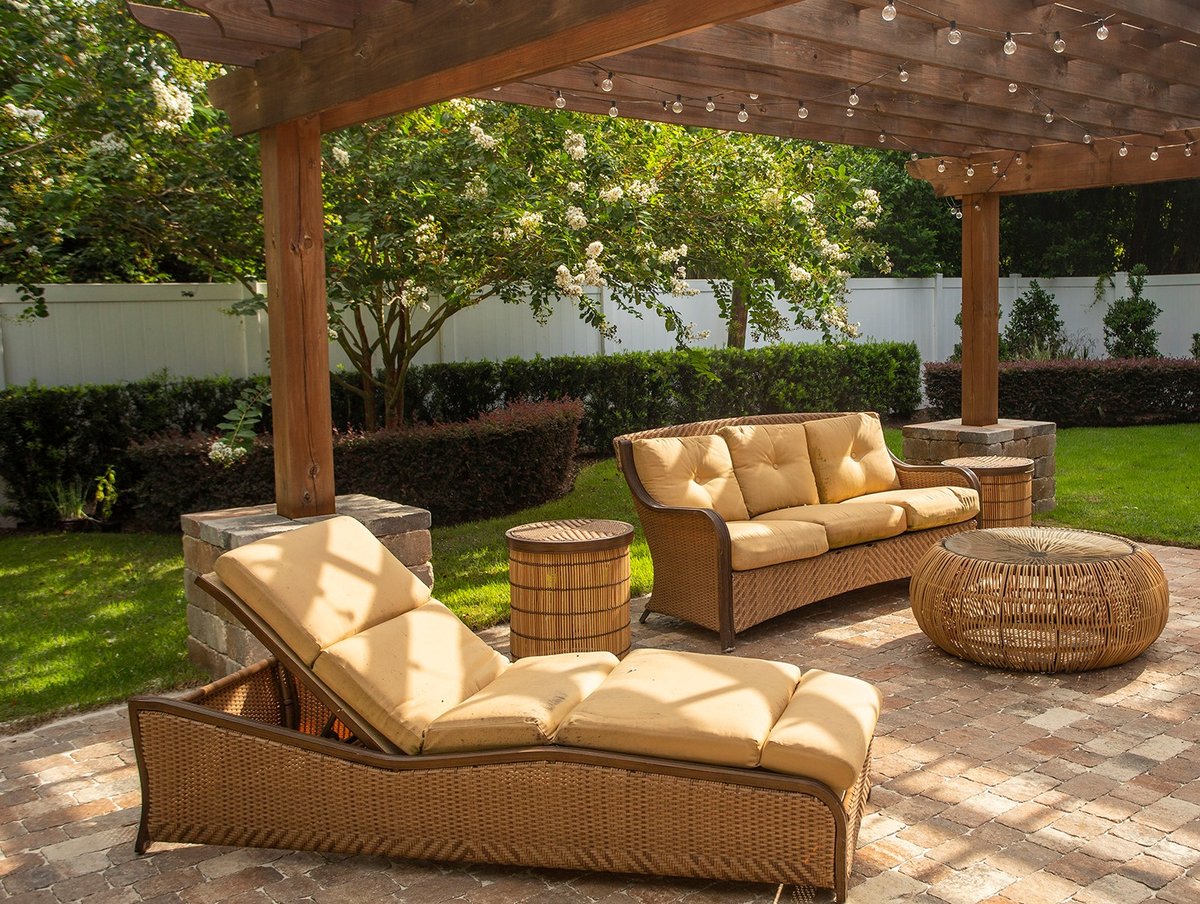 pergola with stone patio and lounge chairs