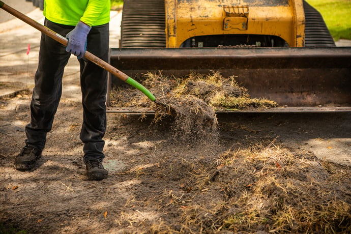 Professionals performing sod removal