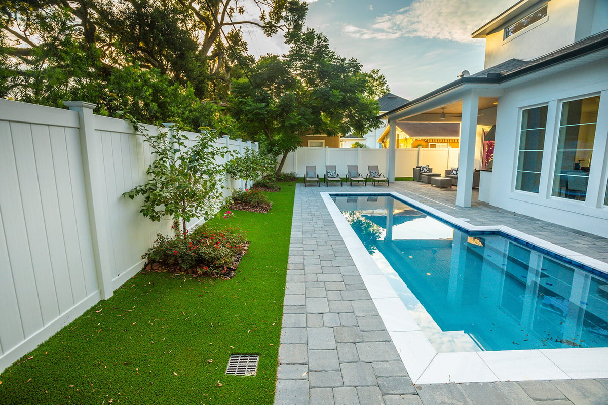 patio and artificial grass around pool