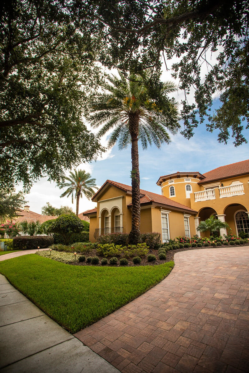 paver driveway in front of spanish colonial home