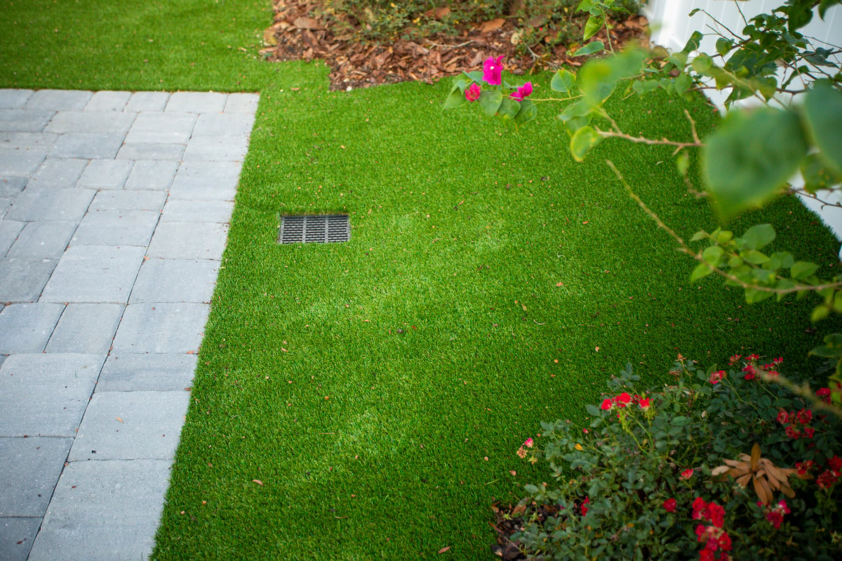 artificial turf near patio with plantings and drainage