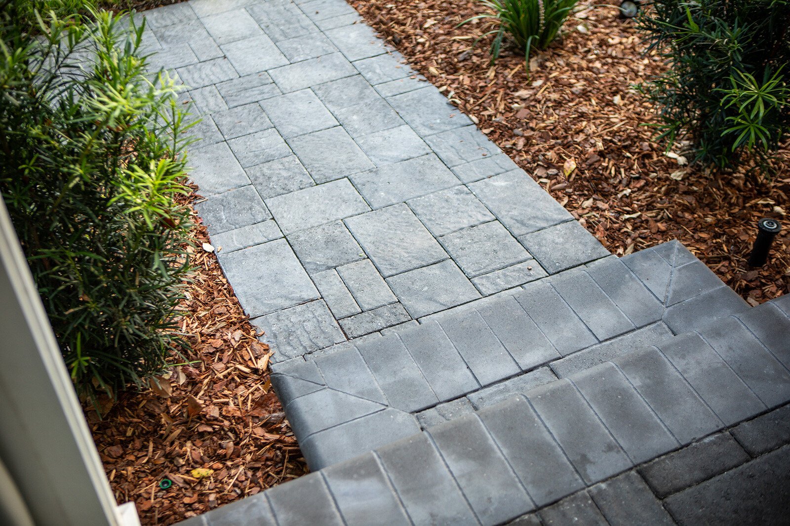 paver walkway with stairs and planting beds
