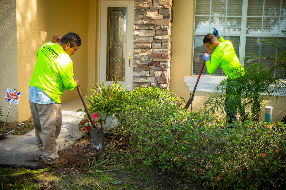 landscaping team installs new landscape bed and plantings