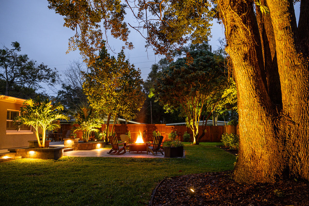 backyard with patio fire feature and tropical plantings