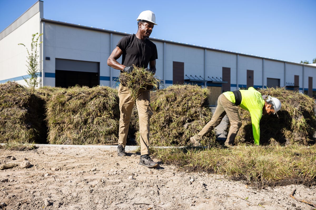 commercial landscape construction team installing new sod at an industrial property in central florida