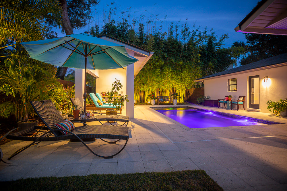 pool with patio and landscape lighting