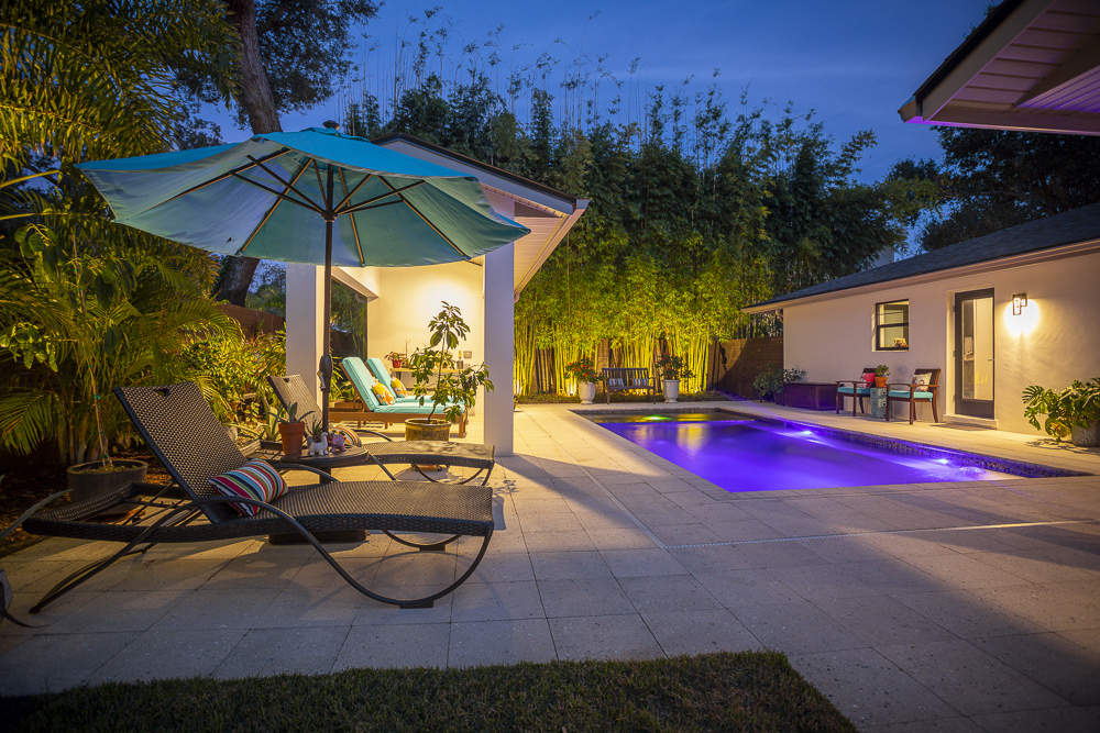 pool with patio and landscape lighting