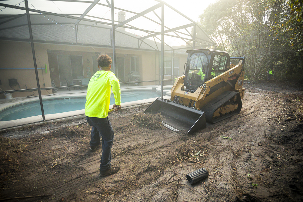 landscape technicians preparing a central florida lawn for sod by replacing soil