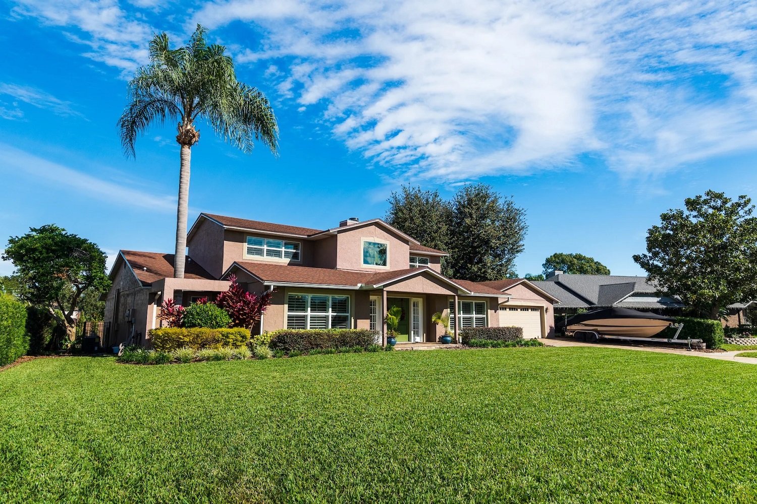 florida home with sod lawn and palm tree