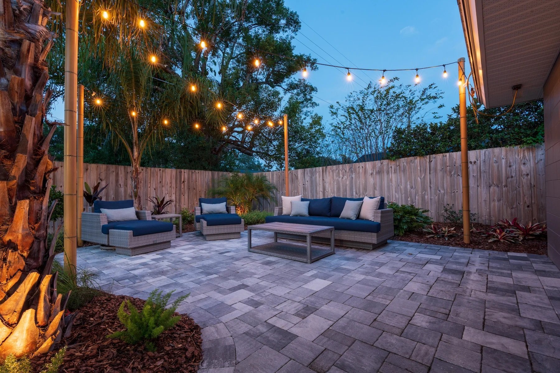 backyard patio with outdoor furniture and landscape lights