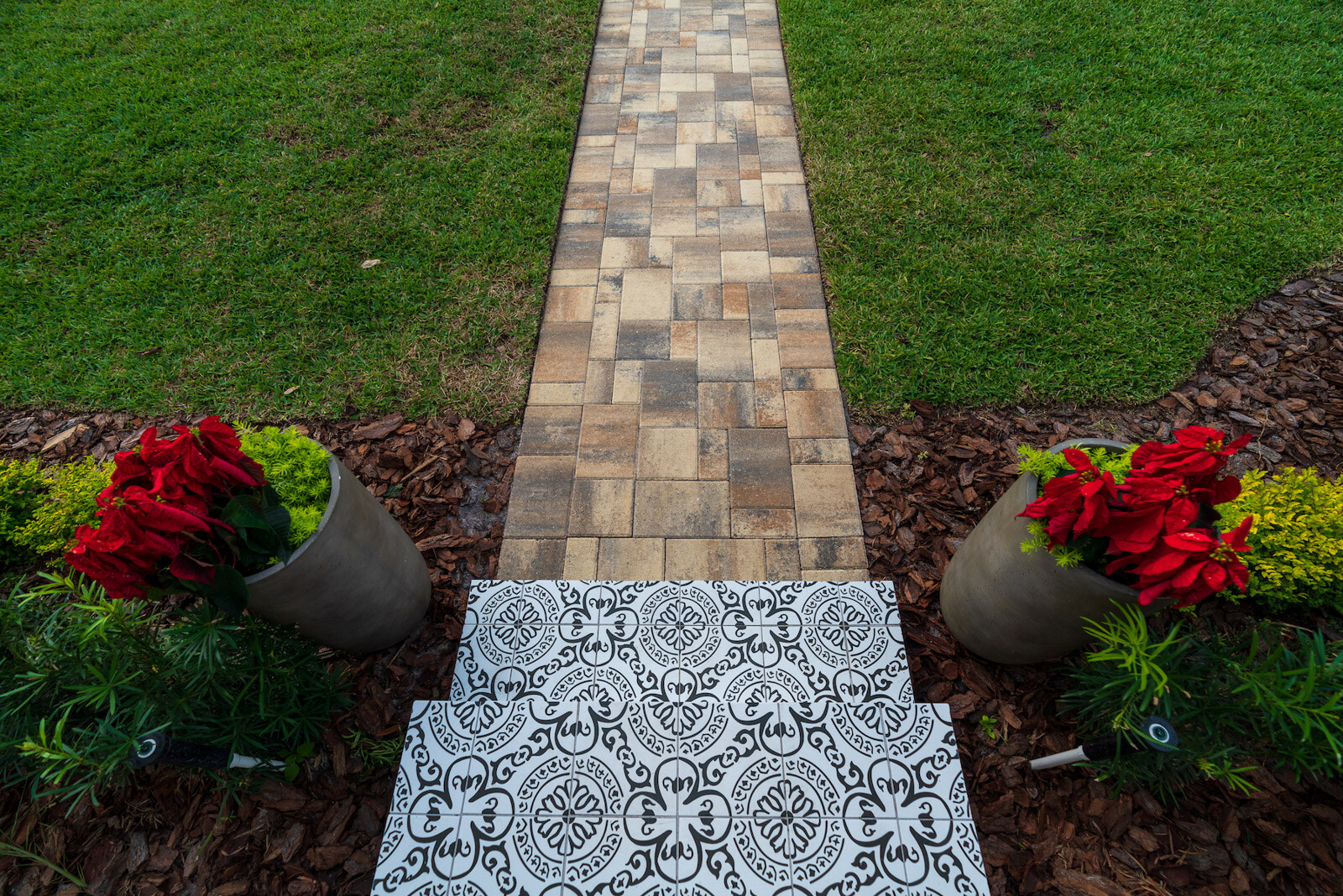 container gardens in landscape bed with walkway