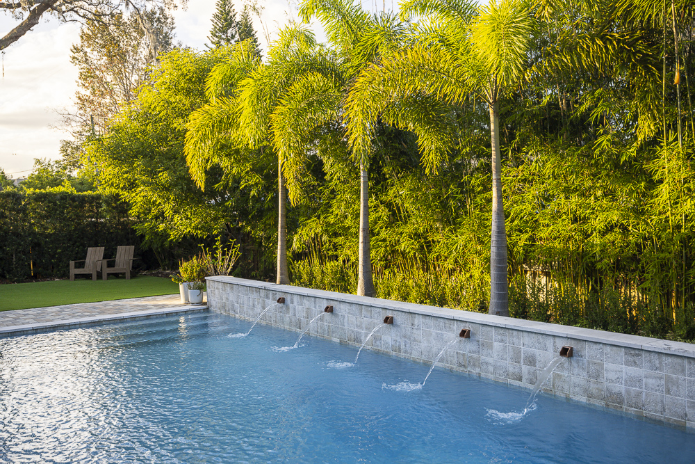 palm trees near pool with fountains