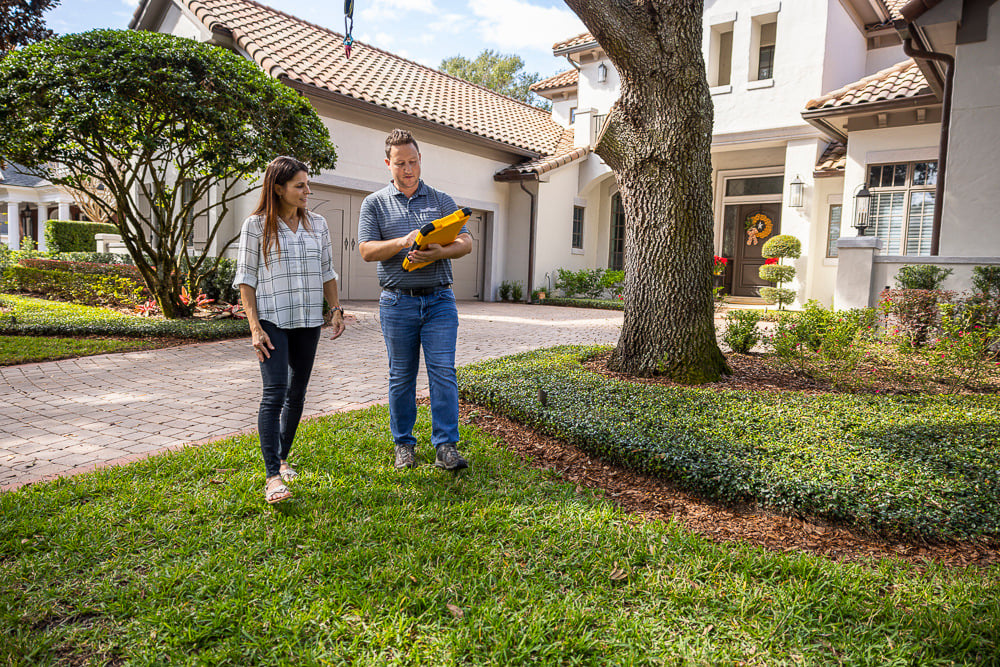 orlando homeowner and landscape designer doing walkthrough of a nice central florida backyard