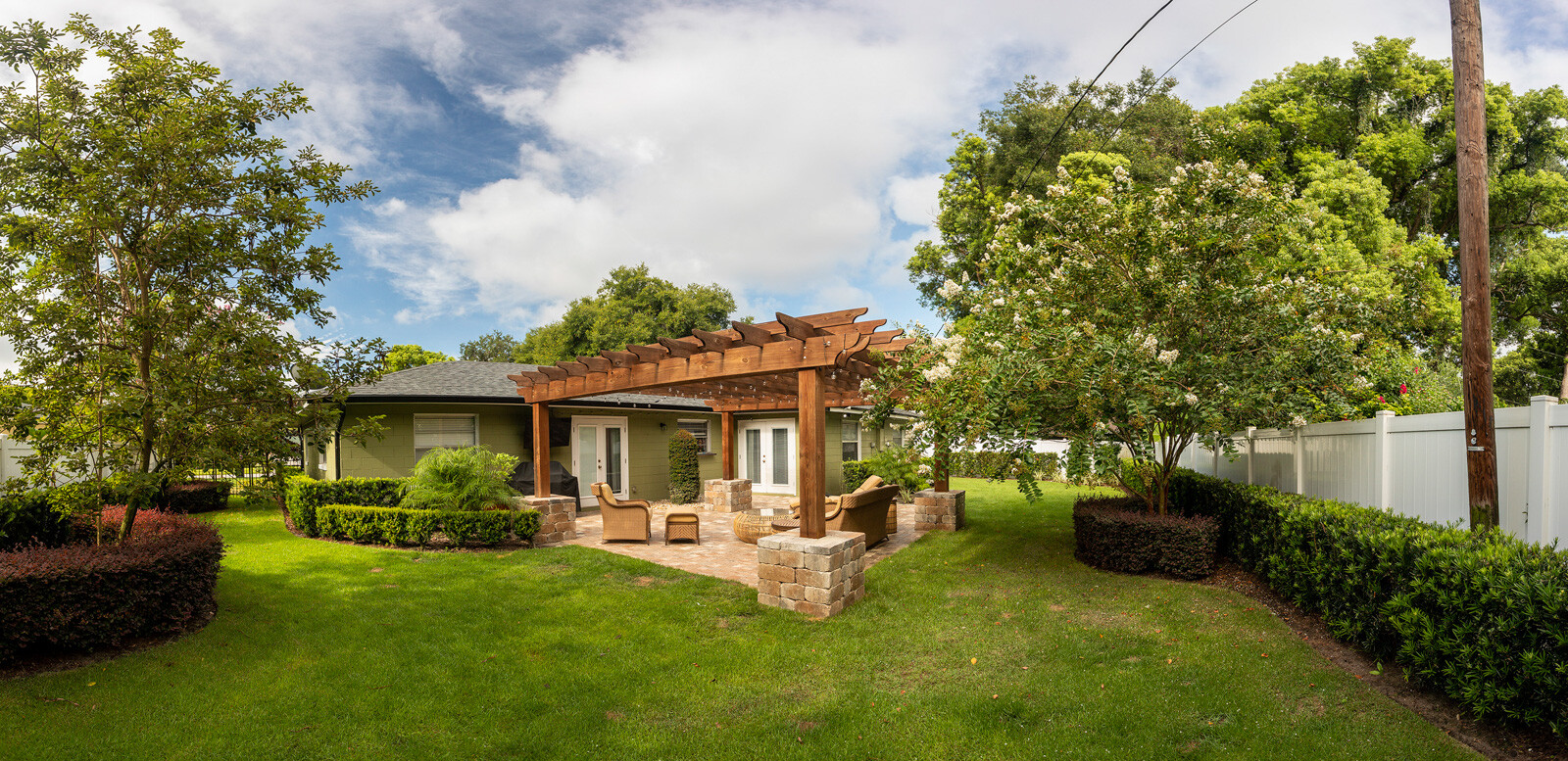 pergola with patio and beautiful landscaping